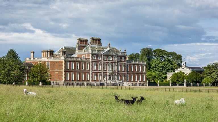 The south front of Wimpole Hall, Cambridgeshire with sheep in the foreground